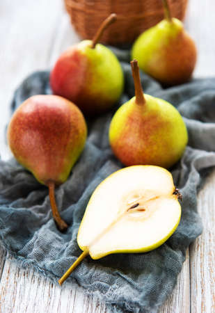 Fresh pears on a old wooden tableの写真素材