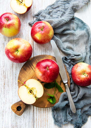 Fresh red apples on a old white wooden backgroundの写真素材