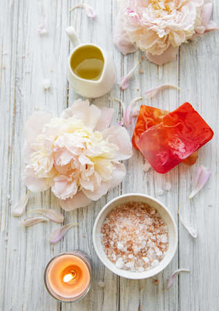 SPA concept: composition of spa treatment with natural sea salt, aromatic oil and peonies flowersの写真素材
