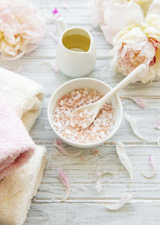 SPA concept: composition of spa treatment with natural sea salt, aromatic oil and peonies flowersの写真素材