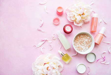 SPA concept: composition of spa treatment with natural sea salt, aromatic oil and peonies flowersの写真素材
