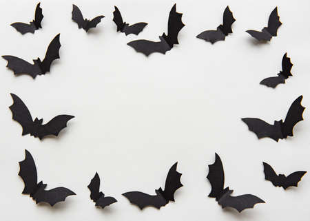 halloween  concept - black paper bats flying over grey backgroundの写真素材