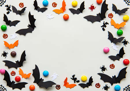 holidays  concept - halloween paper decorations and sweets with blank copy space over grey backgroundの写真素材