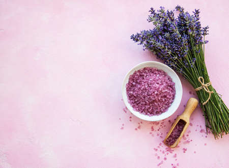 Flat lay composition with lavender flowers and natural sea salt on pink concreteの写真素材