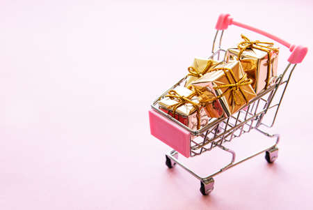 Online shopping concept - trolley cart full of presents. Christmas holiday concept.の写真素材