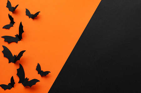 holidays  concept - halloween paper decorations  with blank copy space over orange and black backgroundの写真素材