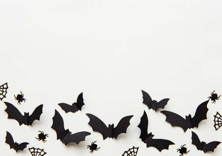 halloween  concept - black paper bats flying over grey backgroundの写真素材