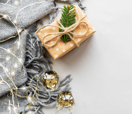 Warm, cozy winter  scarf,  garland and gift box on white background. Christmas concept flat lay.の写真素材