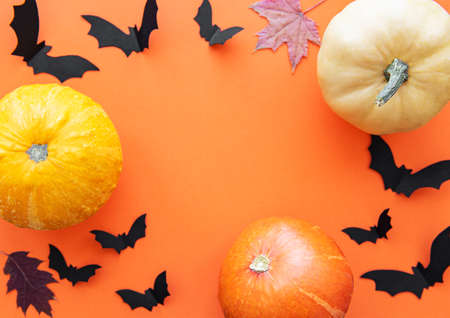 Halloween decorations on orange background. Halloween concept. Flat lay, top view, copy space