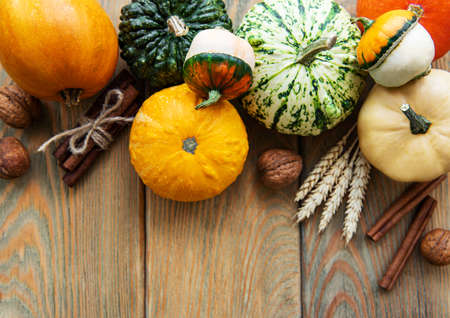Pumpkins  on a wooden background. Pumpkin harvest. Seasonal vegetables