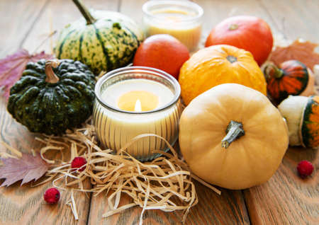Pumpkins  on a wooden background with straw. Pumpkin harvest. Seasonal vegetablesの写真素材