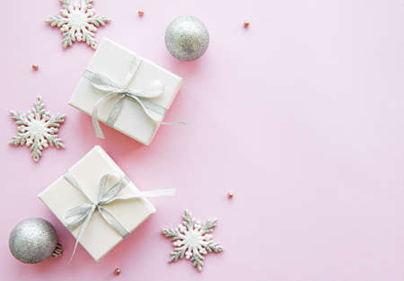 Christmas gift boxes and decorations on a light pink background. Flat lay. Copy space. の写真素材