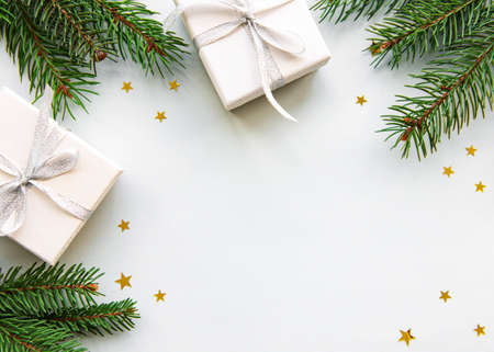 Christmas gift boxes with fir  on white background. Copy space. Top view, flat lay