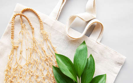 Reusable shopping bags on white background. Ecological concept. Top view of mesh bag and cotton bag. Caring for the environment and the rejection of plastic.の写真素材