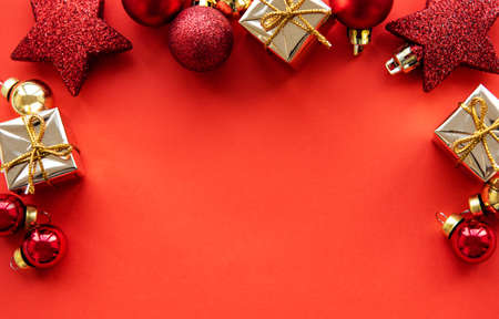Flat lay Christmas composition with holiday  decorations  on red background.