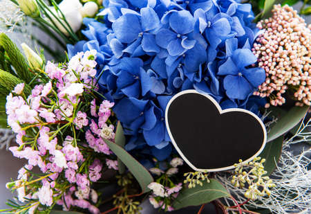 Beautiful blossoming flower bouquet of fresh hydrangea, eustoma, flowers in pink and white colors.  Happy holidays gift.の写真素材