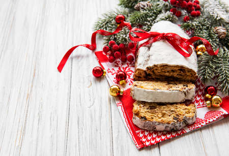 Christmas stollen on wooden background. Traditional Christmas festive pastry dessert. Stollen for Christmas.の写真素材