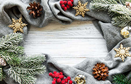 Christmas time composition with grey scarf and decorations.