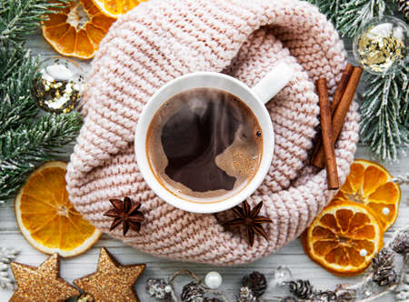 Flat lay Christmas composition with cup of coffee, decorations and  fir tree on a white wooden...