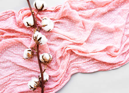 Ð¡otton flower and female scarf on a white background. Flat lay.の写真素材