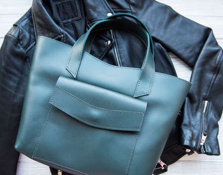 Green leather bag and womens clothing, flat layの写真素材