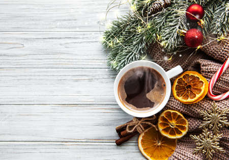 Flat lay Christmas composition with coffee, decorations and  fir tree on a white wooden table.の写真素材