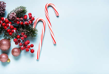 Christmas holiday background. Border made of  decorations on light blue background. Christmas, winter, new year concept. Flat lay, top view, copy spaceの写真素材