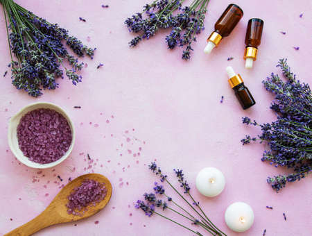Flat lay composition with lavender flowers and natural cosmetic on pink concrete backgroundの写真素材