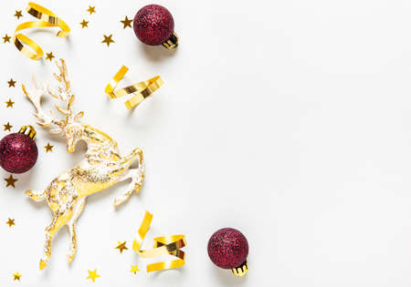 Christmas composition. Red and golden  decoration on white background. Christmas, winter, new year concept. Flat lay, top view, copy spaceの写真素材