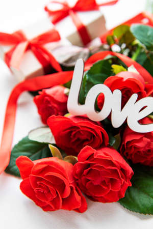 Red roses and gift boxes on a white background. Valentines concept. の写真素材