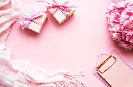 Beauty composition with clipboard, gift boxes hydrangea and accessory on pinkの写真素材