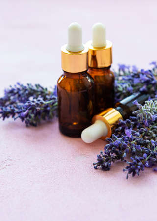 Lavender flowers and natural oil on pink concrete backgroundの写真素材