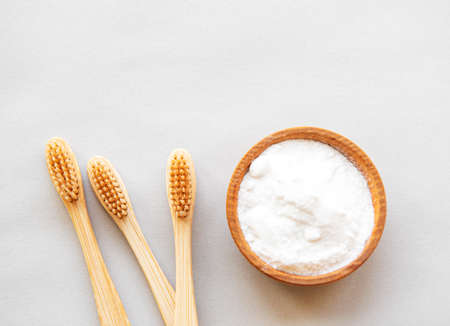 Wooden bamboo eco friendly toothbrushes, baking soda  on white background. Dental care and zero waste conceptの写真素材