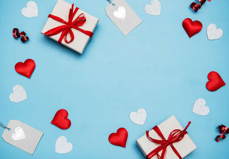 Valentine's Day background. Gifts, confetti on pastel blue background. Valentines day concept. Flat...