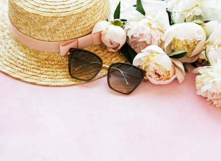 Holiday summer background. Pink peonies and straw hat の写真素材
