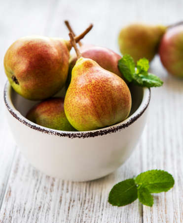 Pears in a bowl on a old wooden table