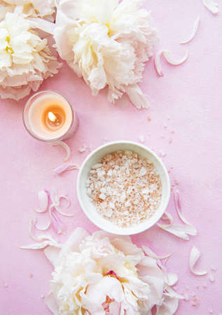 SPA concept: composition of spa treatment with natural sea salt, aromatic oil and peonies flowersの写真素材