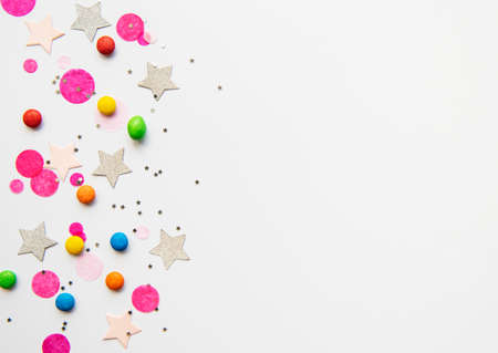 Happy birthday concept, confetti and multicolored candy  on a white background. flat lay, top viewの写真素材