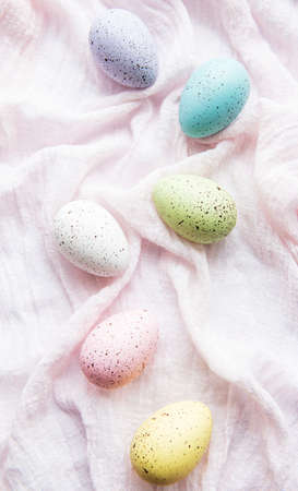 Colorful Easter eggs on pink fabric  background. Top view, flat lay.の写真素材