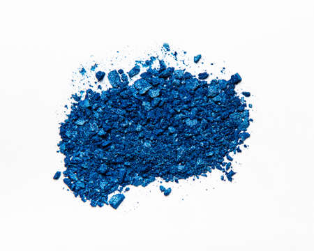 A broken colored in color of year 2020 classic blue eye shadow make up palette. Flat lay. Top view.