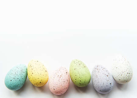 Colorful Easter eggs on white background.  Easter holiday concept, flat lay, top view.の写真素材