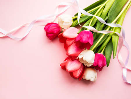 Beautiful tulips bouquet on a pink pastel  backgroundの写真素材