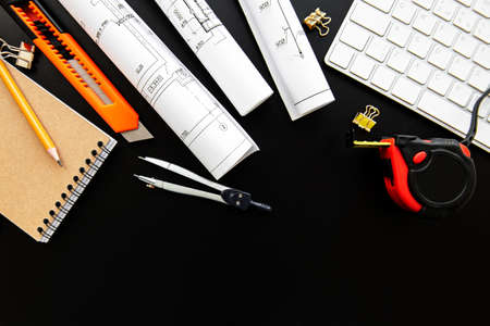 Architect workplace top view. Architectural project, blueprints, blueprint rolls on table....