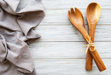 Old vintage kitchen utensils. Wooden spoons,  napkin over white wooden table. Top viewの写真素材