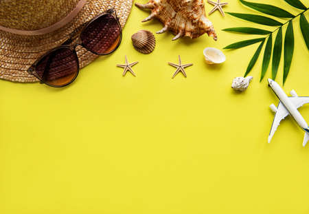 Flat lay traveler accessories on yellow background with blank space for text. Top view travel or vacation concept. Summer background.の写真素材