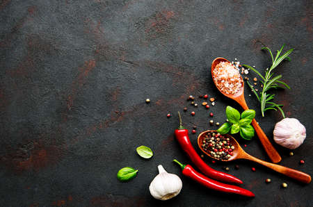 Top view of spices on dark concrete background. Flat lay.
