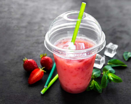 Refreshing summer drink with strawberry on a black background