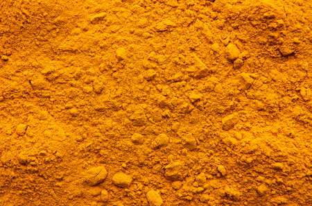 Background made of yellow turmeric powderの写真素材