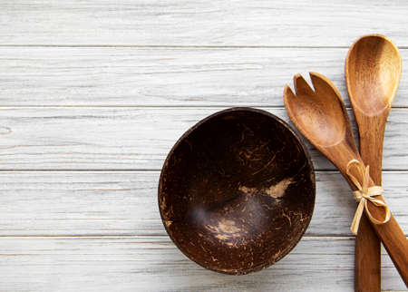 Top view on a wooden cutlery kitchen ware on a wooden background, flat layの写真素材