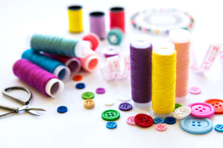 Color threads and sewing accessories on white backgroundの写真素材